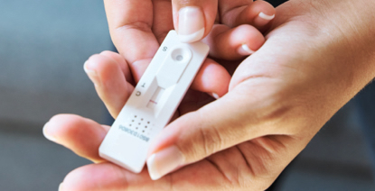 hands holding a COVID 19 test